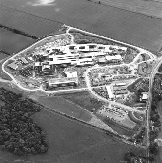 Oblique aerial view centred on the Royal Infirmary of Edinburgh at Little France under construction, taken from the NW.