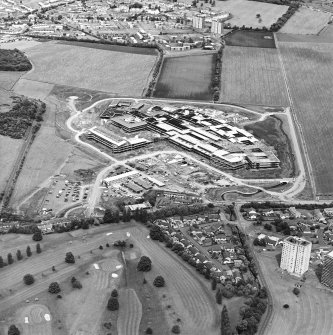Oblique aerial view centred on the hospital under construction, taken from the SW.