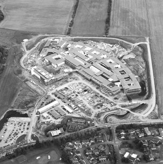 Oblique aerial view centred on the hospital under construction, taken from the SW.