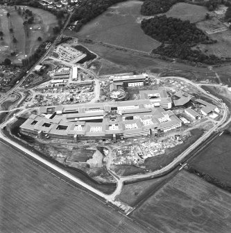 Oblique aerial view centred on the hospital under construction, taken from the E.