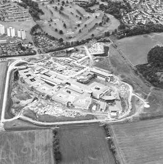 Oblique aerial view centred on the hospital under construction, taken from the NE.