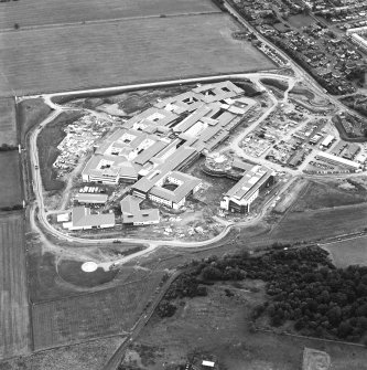 Oblique aerial view centred on the hospital under construction, taken from the NW.