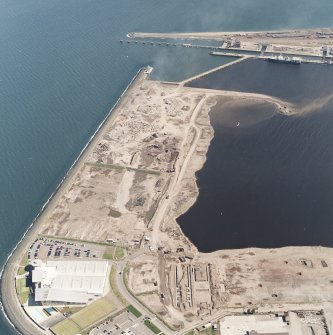Oblique aerial view centred on the breakwater with the docks adjacent, taken from the SW.