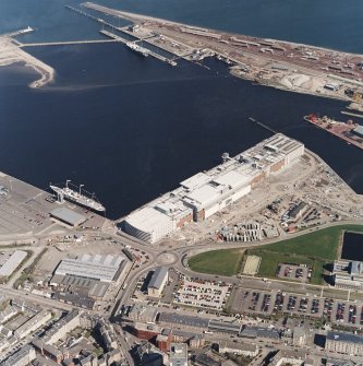 Oblique aerial view centred on the docks and the construction of the shopping centre, cinema, restaurants and visitor centre, taken from the S.