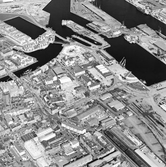 Oblique aerial view centred on the road bridge with the docks adjacent, taken from the ESE.
