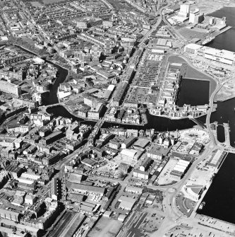 Oblique aerial view centred on the road bridge with the docks adjacent, taken from the E.
