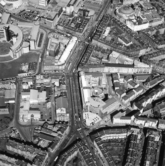 Oblique aerial view centred on the redevelopment of the cinema with the bank, shop and offices adjacent, taken from the SE.