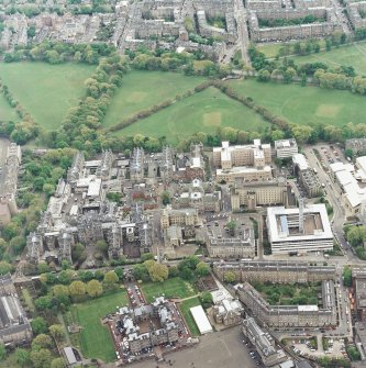 Oblique aerial view centred on the hospital with the chapel, hospital and school adjacent, taken from the NNW.