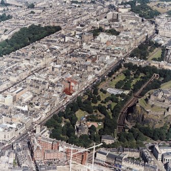 Oblique aerial view, taken from the SW, showing the New Town in the centre of the photograph, and centred on Princes Street and Princes Street Gardens.