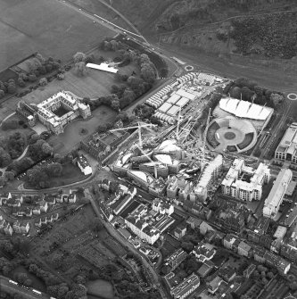 Oblique aerial view centred on the construction of the Scottish Parliament with exhibition centre and palace adjacent, taken from the WNW.