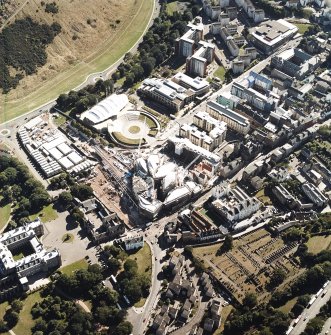 Oblique aerial view centred on the construction of the Scottish Parliament with the exhibition centre and palace adjacent, taken from the N.