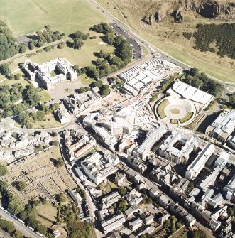 Oblique aerial view centred on the construction of the Scottish Parliament with the exhibition centre and palace adjacent, taken from the WNW.