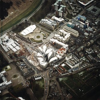 Oblique aerial view centred on the construction of the Scottish Parliament with `Our Dynamic Earth¿ adjacent, taken from the NNE.