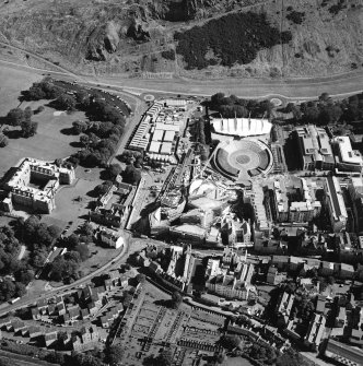 Oblique aerial view centred on the construction of the Scottish Parliament with the exhibition centre and palace adjacent, taken from the NNW.