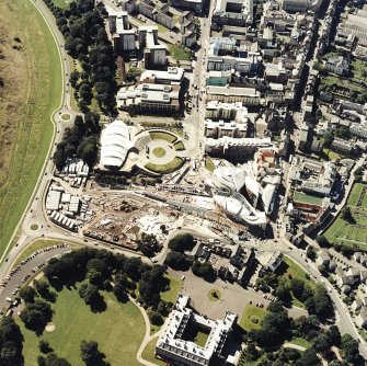 Oblique aerial view centred on the Scottish parliament building with `Our Dynamic Earth¿ and Holyrood palace adjacent, taken from the NE.
