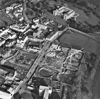 Oblique aerial view of Edinburgh centred on the Scottish Parliament and 'Our Dynamic Earth' under construction and the Canongate and Holyrood Palace, taken from the SW.