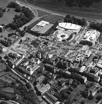 Oblique aerial view centred on the construction site, with exhibition centre and Queensbury House adjacent, taken from the N.