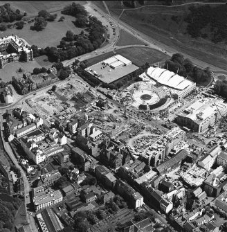 Oblique aerial view centred on the construction site, with exhibition centre and Queensbury House adjacent, taken from the NW.