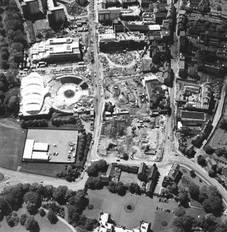 Oblique aerial view centred on the construction site, with exhibition centre and Queensbury House adjacent, taken from the E.