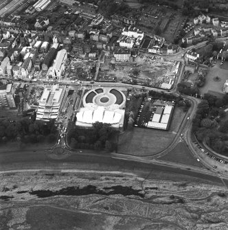 Oblique aerial view centred on the Scottish parliament under construction with `Our Dynamic Earth¿ adjacent, taken from the SE.