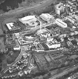 Oblique aerial view centred on the Scottish parliament under construction with `Our Dynamic Earth¿ adjacent, taken from the NNW.