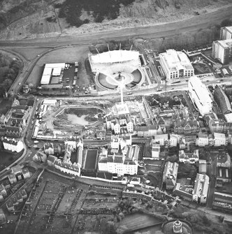 Oblique aerial view centred on the Scottish parliament under construction with `Our Dynamic Earth¿ adjacent, taken from the NW.