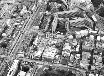 Oblique aerial view centred on the construction of the shop and the bus station with the bank adjacent, taken from the WSW.