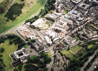 Oblique aerial view centred on the construction of the Scottish Parliament with the exhibition centre and palace adjacent, taken from the NNE.