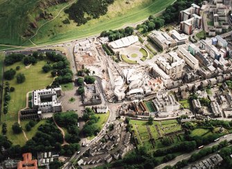 Oblique aerial view centred on the construction of the Scottish Parliament with the exhibition centre and palace adjacent, taken from the NNW.