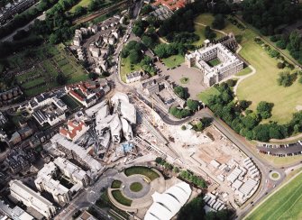Oblique aerial view centred on the construction of the Scottish Parliament with the exhibition centre and palace adjacent, taken from the SSW.