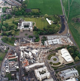 Oblique aerial view centred on the construction of the Scottish Parliament with exhibition centre and palace adjacent, taken from the WSW.