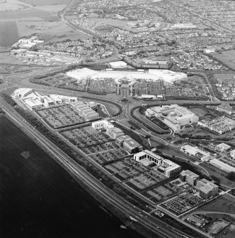 General oblique aerial view looking across the industrial estate towards the shopping centre, taken from the SW.