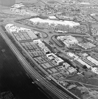 General oblique aerial view looking across the industrial estate towards the shopping centre, taken from the SSW.