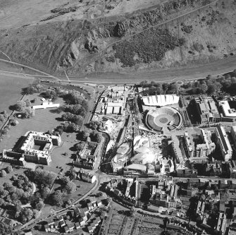 Oblique aerial view centred on the construction of the Scottish Parliament with the exhibition centre and palace adjacent, taken from the NNW.