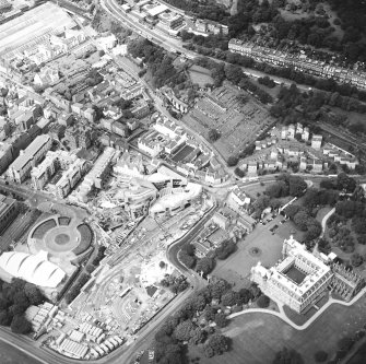 Oblique aerial view centred on the Scottish Parliament under construction with `Our Dynamic Earth' and the palace adjacent, taken from the ESE.
