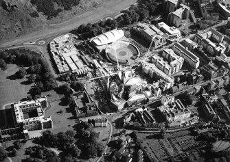 Oblique aerial view centred on the construction of the Scottish Parliament with the exhibition centre and palace adjacent, taken from the NNW.