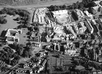 Oblique aerial view centred on the construction of the Scottish Parliament with the exhibition centre and palace adjacent, taken from the NW.