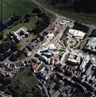 Oblique aerial view centred on the Scottish parliament building with `Our Dynamic Earth¿ and Holyrood palace adjacent, taken from the WNW.
