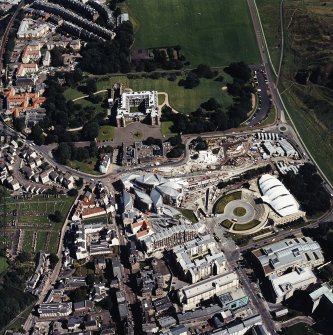 Oblique aerial view centred on the Scottish parliament building with `Our Dynamic Earth¿ and Holyrood palace adjacent, taken from the W.