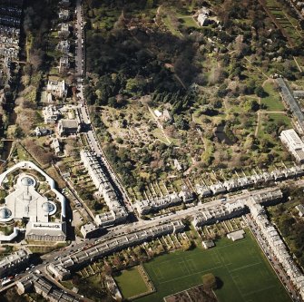 Oblique aerial view of the botanical garden centred on the Herbarium, hall and gate-lodge with the offices adjacent, taken from the ENE.