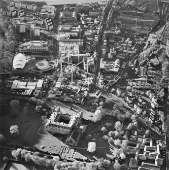Oblique aerial view centred on the construction of the Scottish Parliament with the exhibition centre and palace adjacent, taken from the NE.
