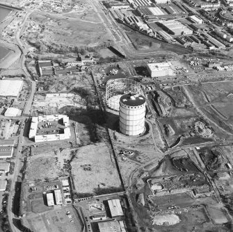 Oblique aerial view centred on the gasworks with the country house adjacent, taken from the W.