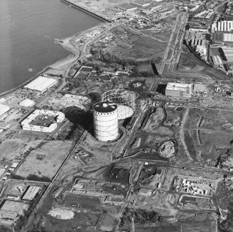 Oblique aerial view centred on the gasworks with the country house adjacent, taken from the WSW.