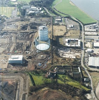 Oblique aerial view centred on the gasworks with the country house adjacent, taken from the E.