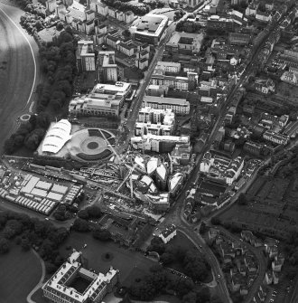 Oblique aerial view centred on the construction of the Scottish Parliament with the exhibition centre adjacent, taken from the NE.