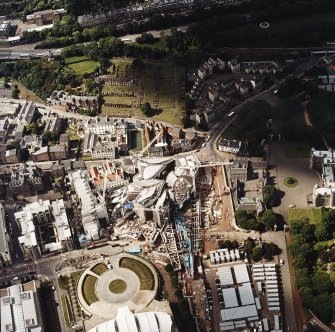 Oblique aerial view centred on the construction of the Scottish Parliament with the exhibition centre adjacent, taken from the WNW.