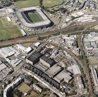 Oblique aerial view centred on the bonded warehouse with the park and bowling green and stadium adjacent, taken from the S.