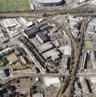 Oblique aerial view centred on the bonded warehouse with the park and bowling green adjacent, taken from the SSE.