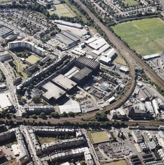 Oblique aerial view centred on the bonded warehouse with the park and bowling green adjacent, taken from the ESE.