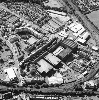 Oblique aerial view centred on the bonded warehouse with the park and bowling green adjacent, taken from the E.